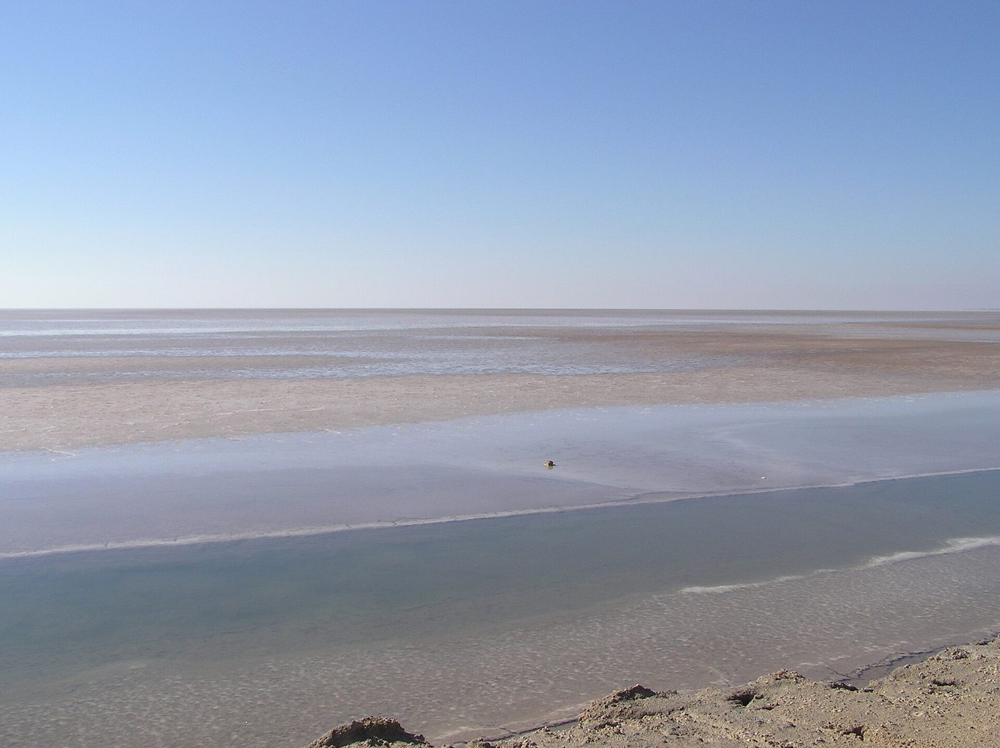 The vast salt pan of Chott el Jerid stretching to the horizon under a wide sky, Tunisia.