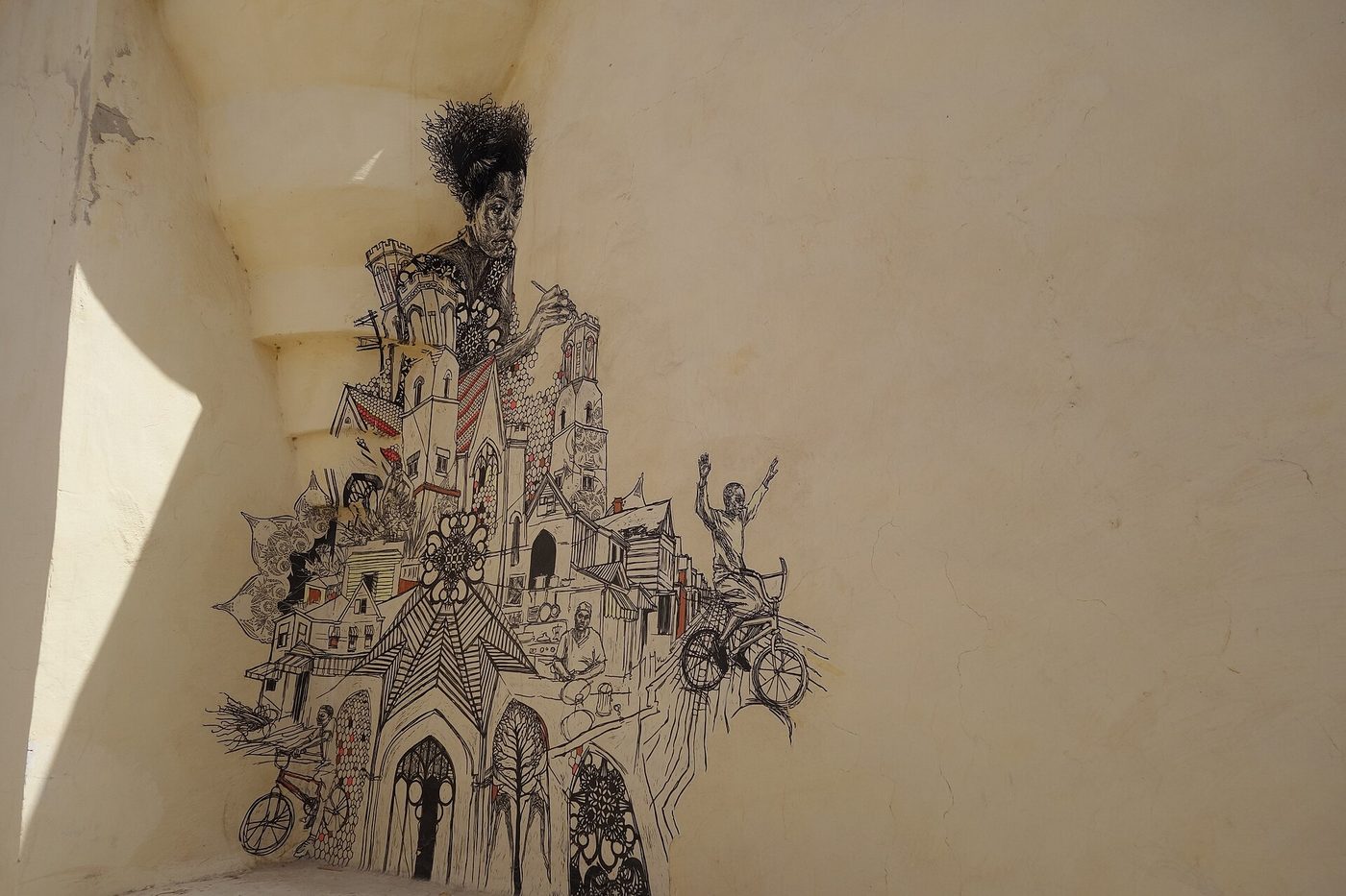 A detailed street-art mural on a whitewashed wall in the Djerbahood district of Erriadh, Djerba