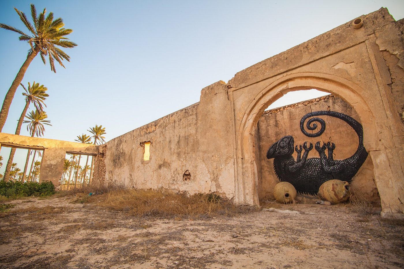 A large street-art mural on a whitewashed wall in the Djerbahood project, Erriadh village, Djerba