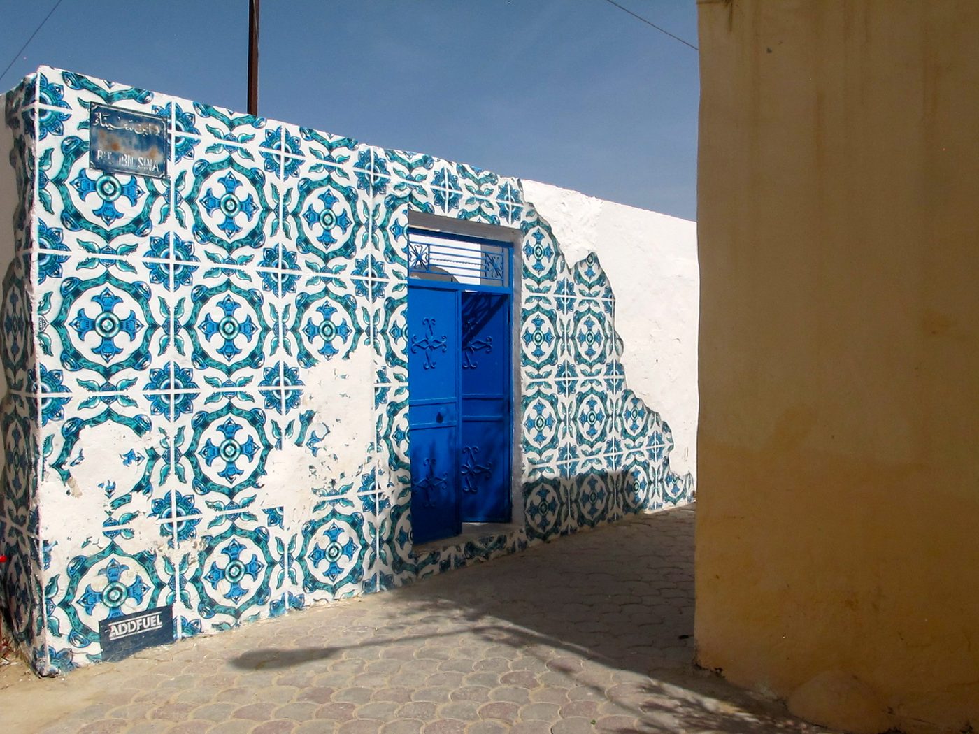 A traditional blue Djerban door reworked into a small artwork as part of the Djerbahood street-art project