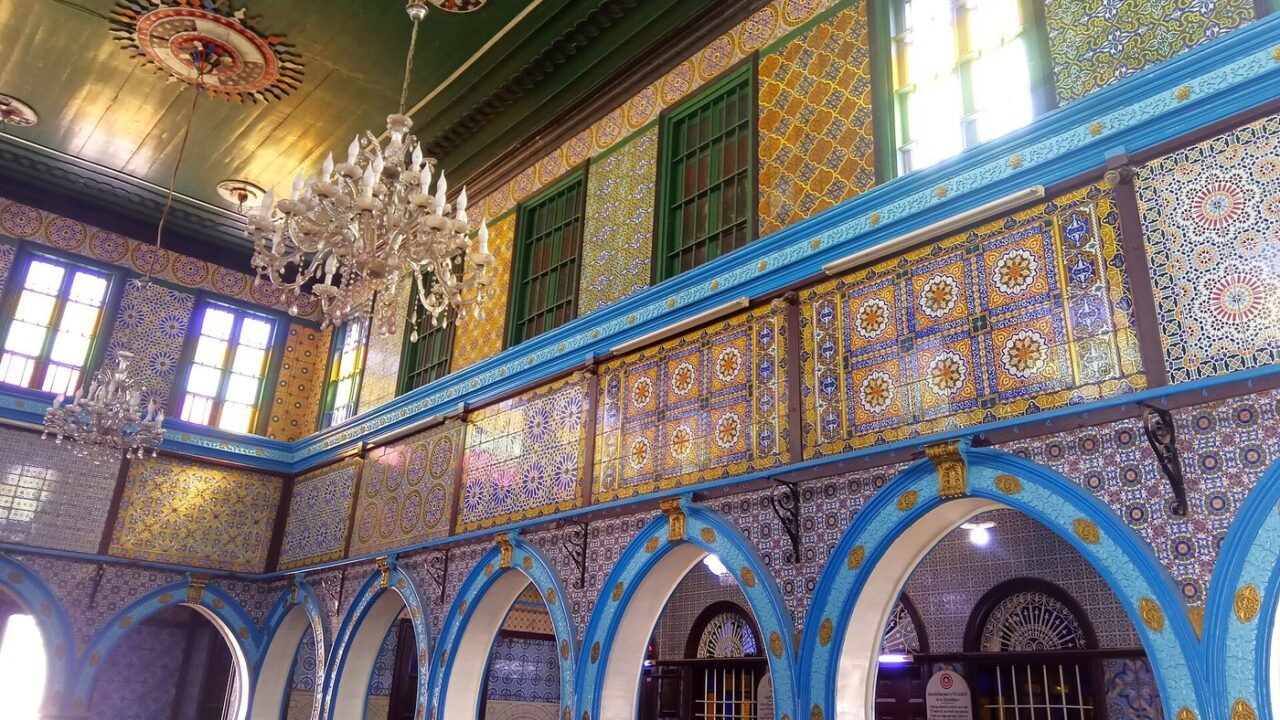 The blue-tiled interior arcades of the El Ghriba synagogue at Erriadh, Djerba