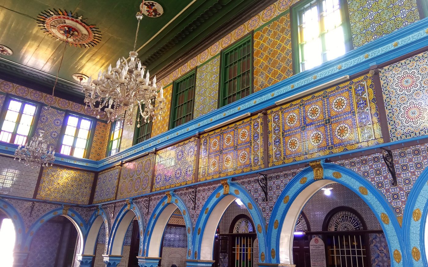 The blue-tiled interior arcades of the El Ghriba synagogue at Erriadh, Djerba