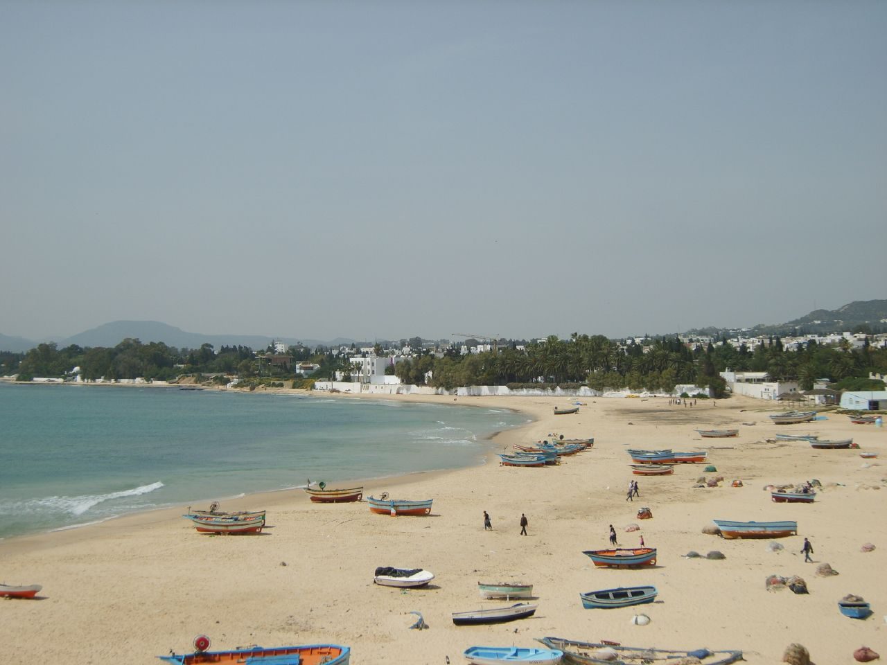 The main beach curving along Hammamet bay