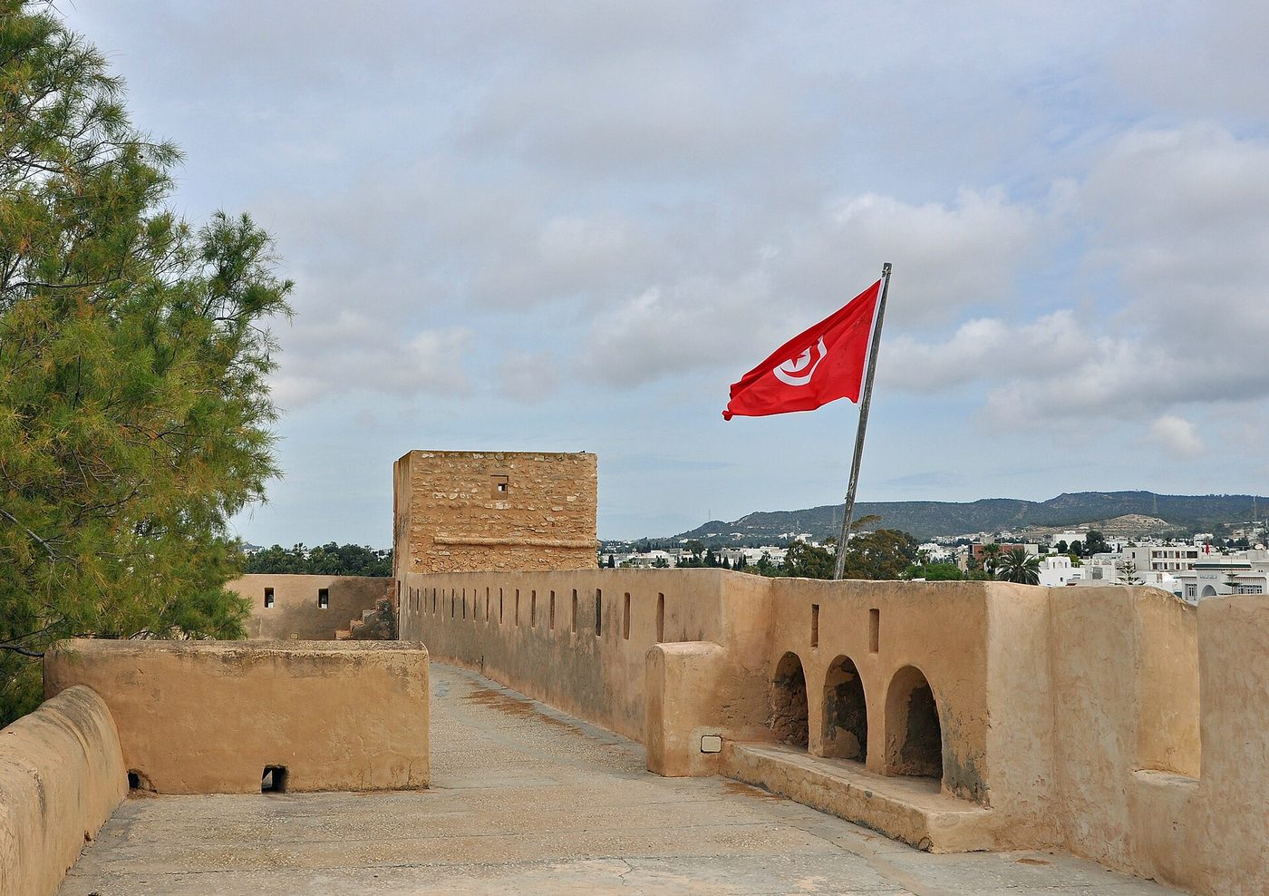 The historic kasbah at Hammamet, with the Tunisian flag flying over the ramparts and the town beyond, on the Cap Bon coast