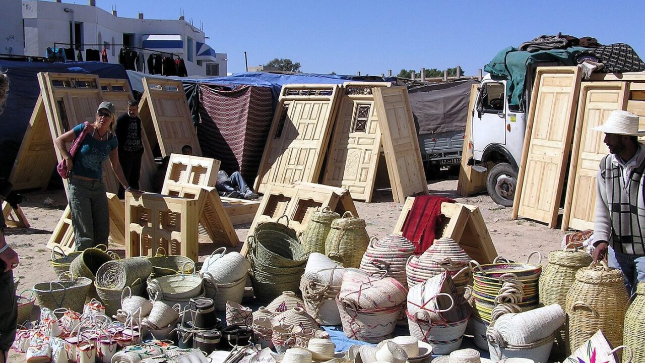A covered market street in Houmt Souk, Djerba, lined with craft and souvenir stalls