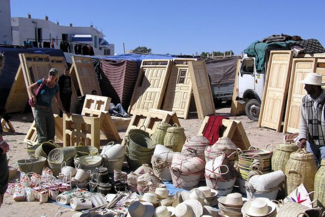 A covered market street in Houmt Souk, Djerba, lined with craft and souvenir stalls