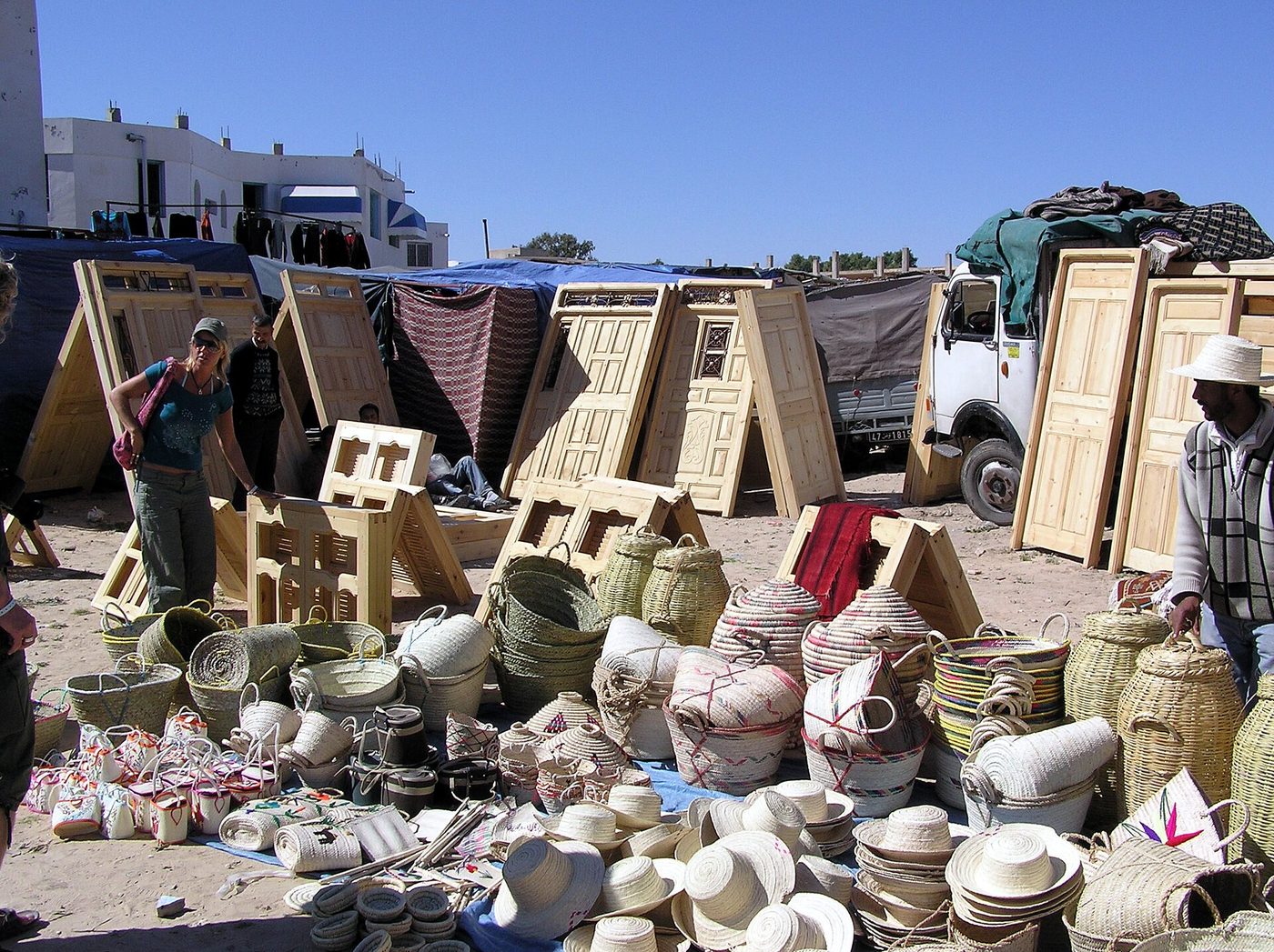 A covered market street in Houmt Souk, Djerba, lined with craft and souvenir stalls