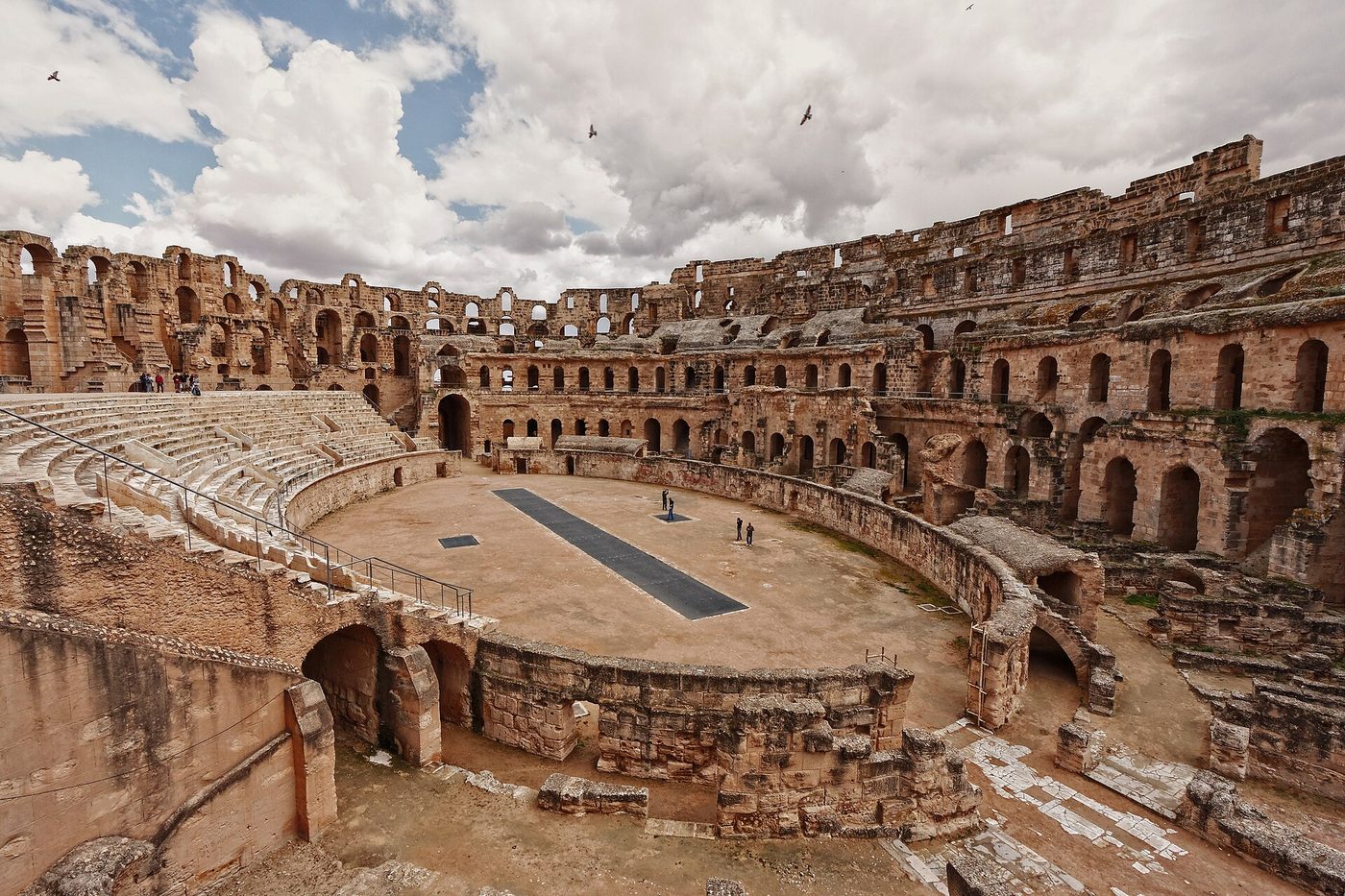 The Roman amphitheatre at El Djem, Tunisia — the great honey-coloured arena and tiered arches, ideally in clear spring light