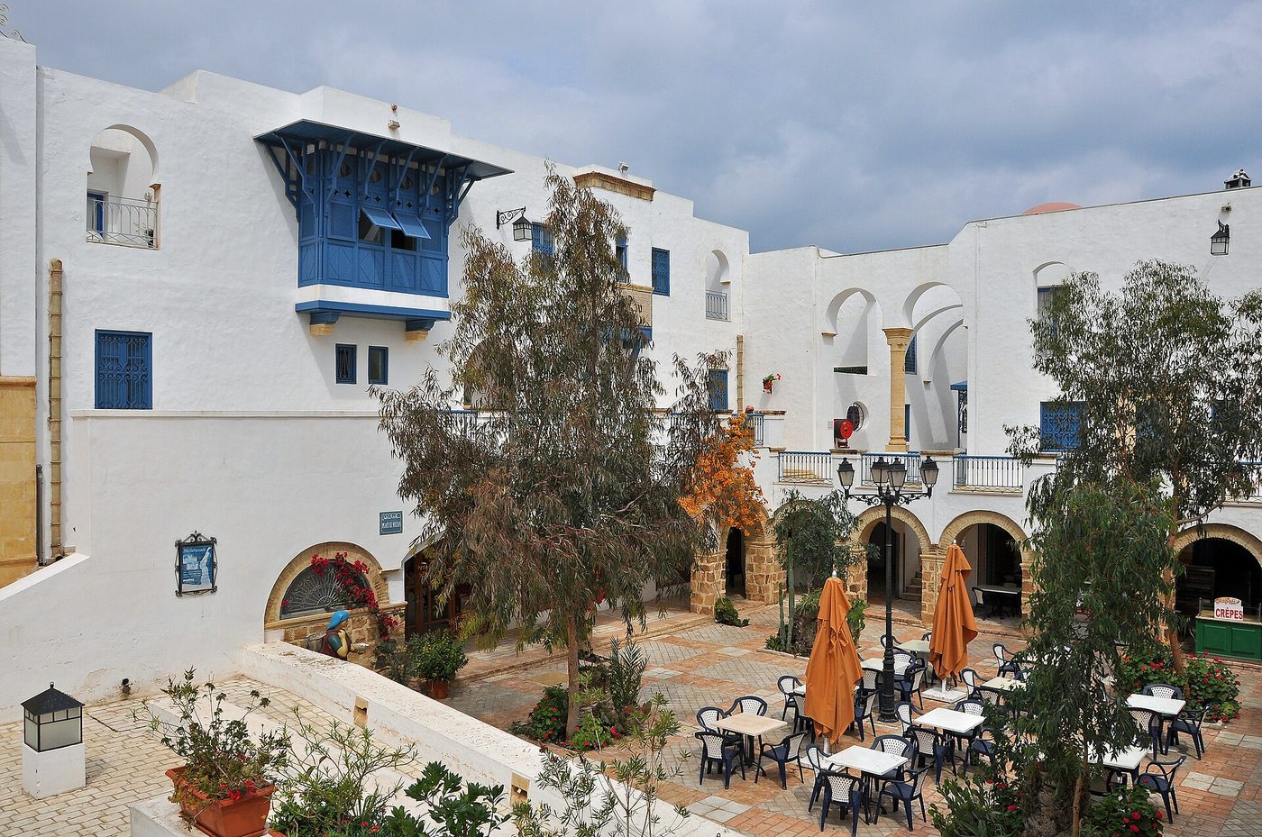 Andalusian-style white-and-blue architecture and a cafe courtyard in Yasmine Hammamet