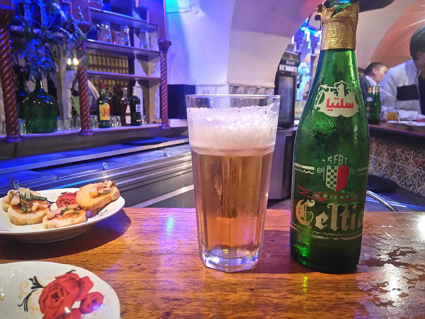 A bottle and glass of Celtia, Tunisia's most common local lager, in a bar