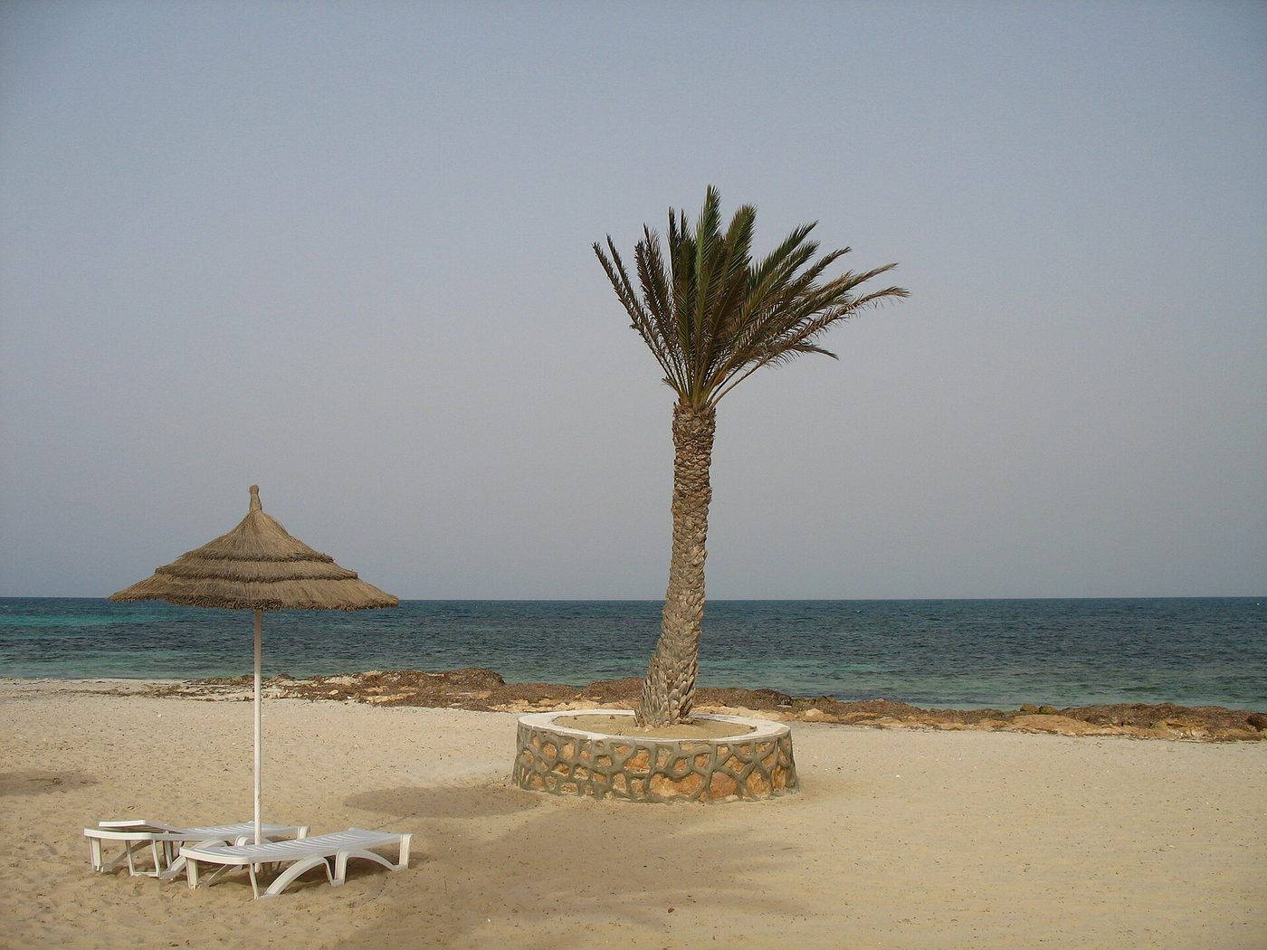 A sandy beach on the island of Djerba with warm early-summer sea
