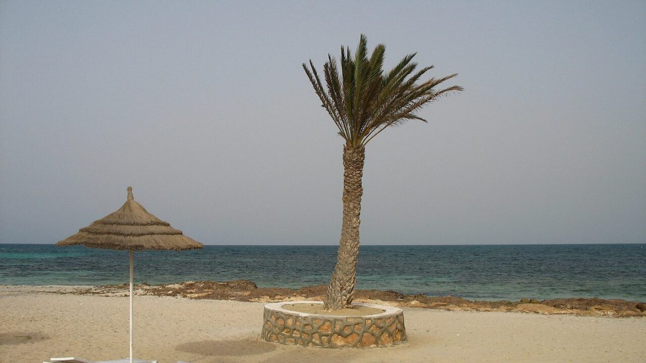A wide sandy beach on Djerba with the warm August sea