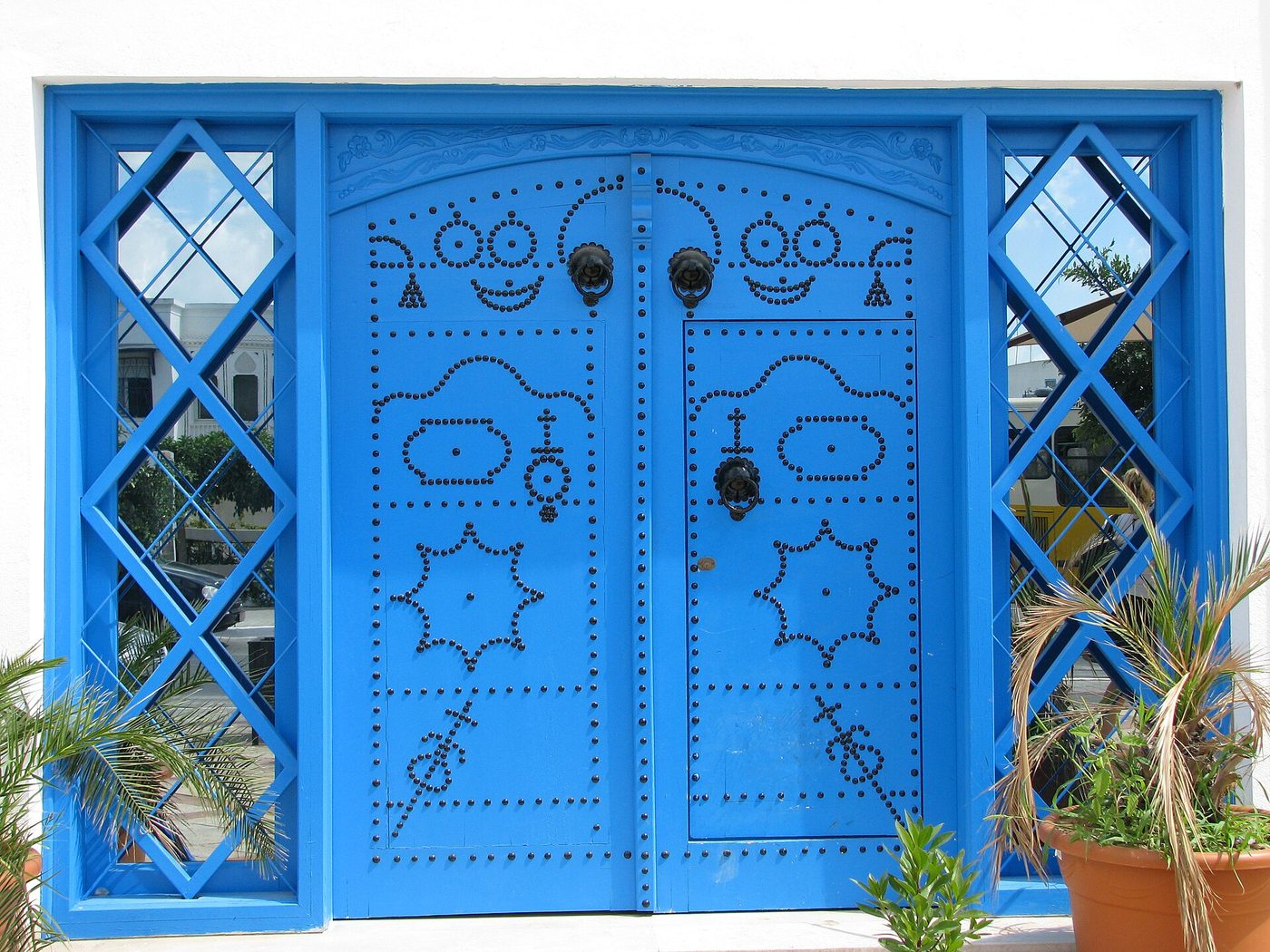 A traditional arched cobalt-blue door studded with black iron nails in Sidi Bou Said