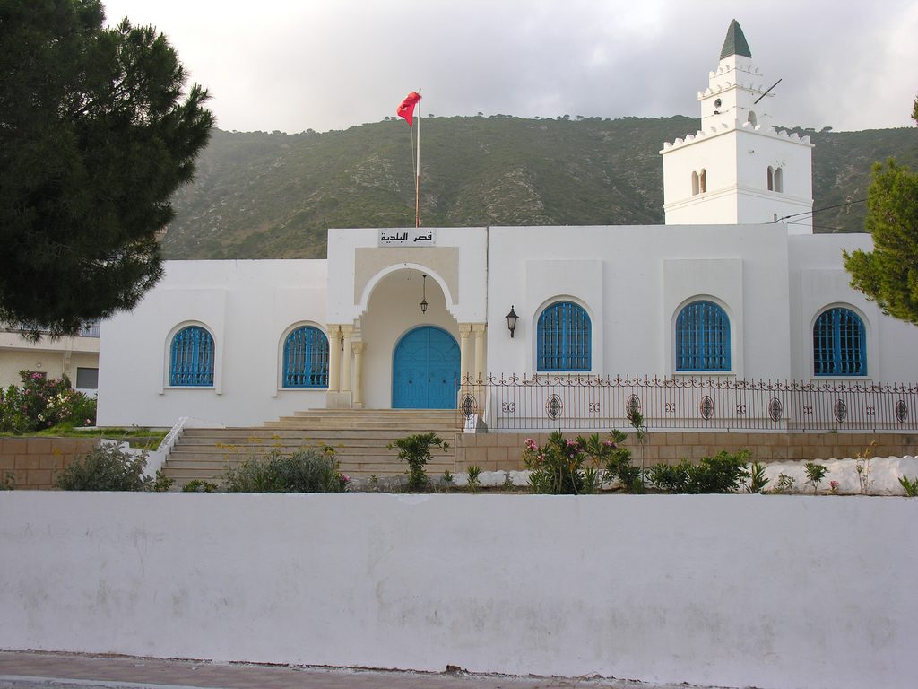The whitewashed municipal building at Ghar el Melh below the Jebel Nadhour hills