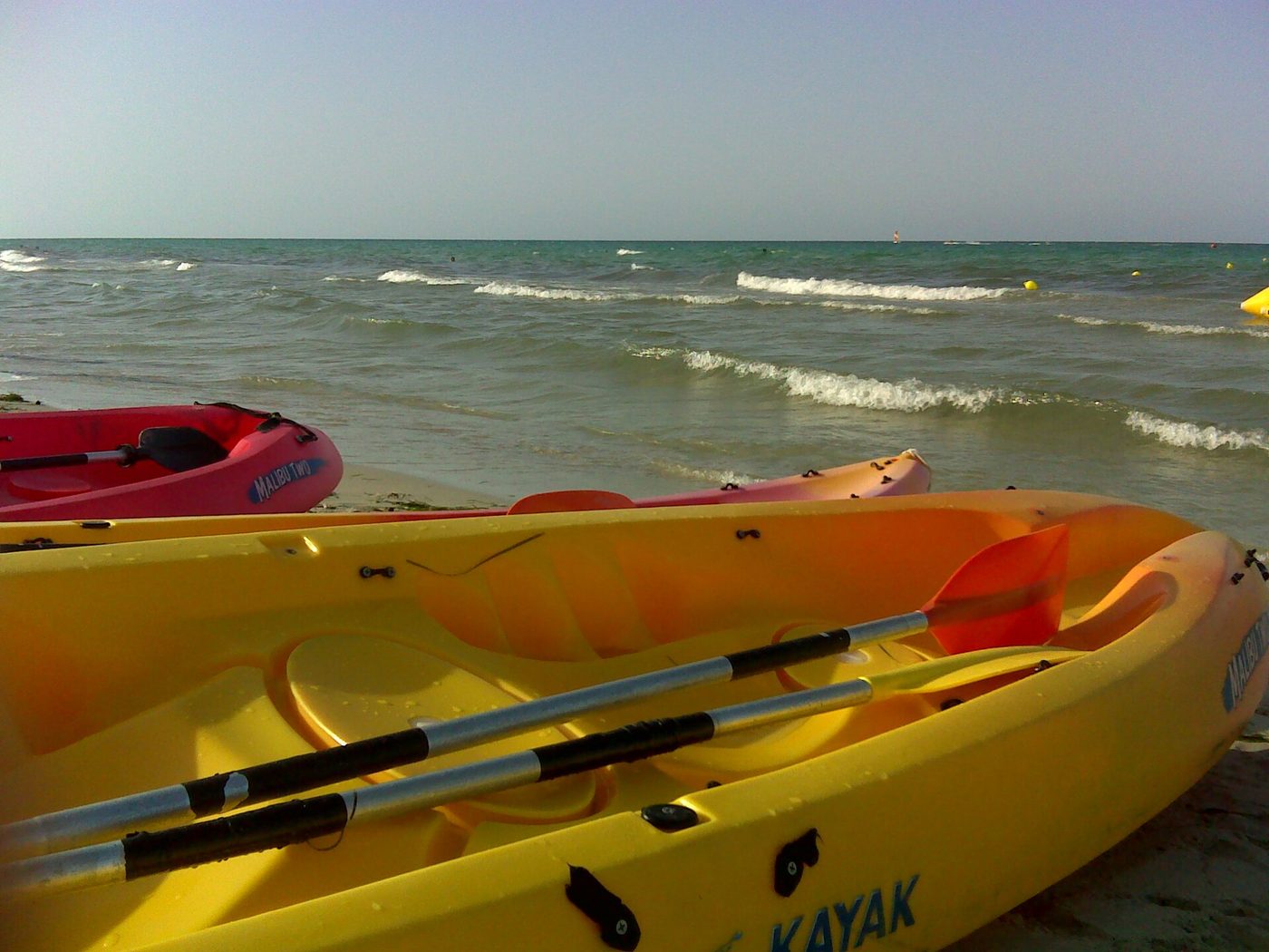 Kayaks and watersports kit drawn up on a Djerba beach