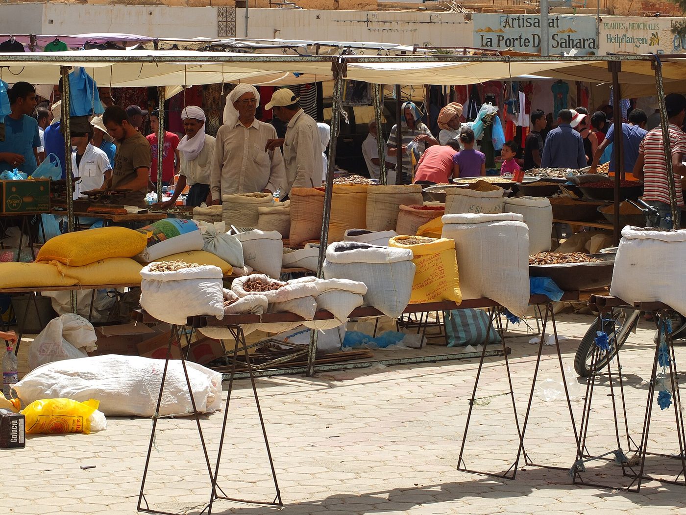The weekly market at Douz, Tunisia — sacks of dates, grain and spices under the awnings