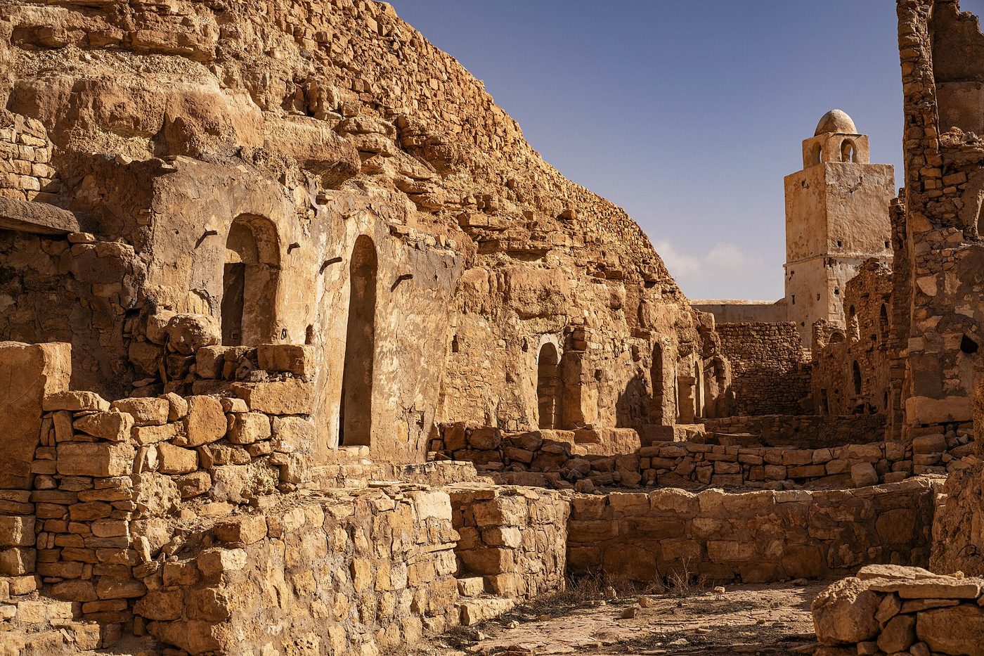 The abandoned Berber hillside village of Douiret in the Tataouine region of southern Tunisia, with its ruined stone houses and mosque